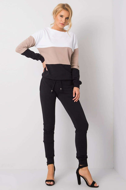 Elegant model showcasing a luxury 2-piece set from Rue Paris featuring a stylish long-sleeve cotton sweatshirt in a chic colour-block design paired with black jogger pants, exuding sophisticated comfort.