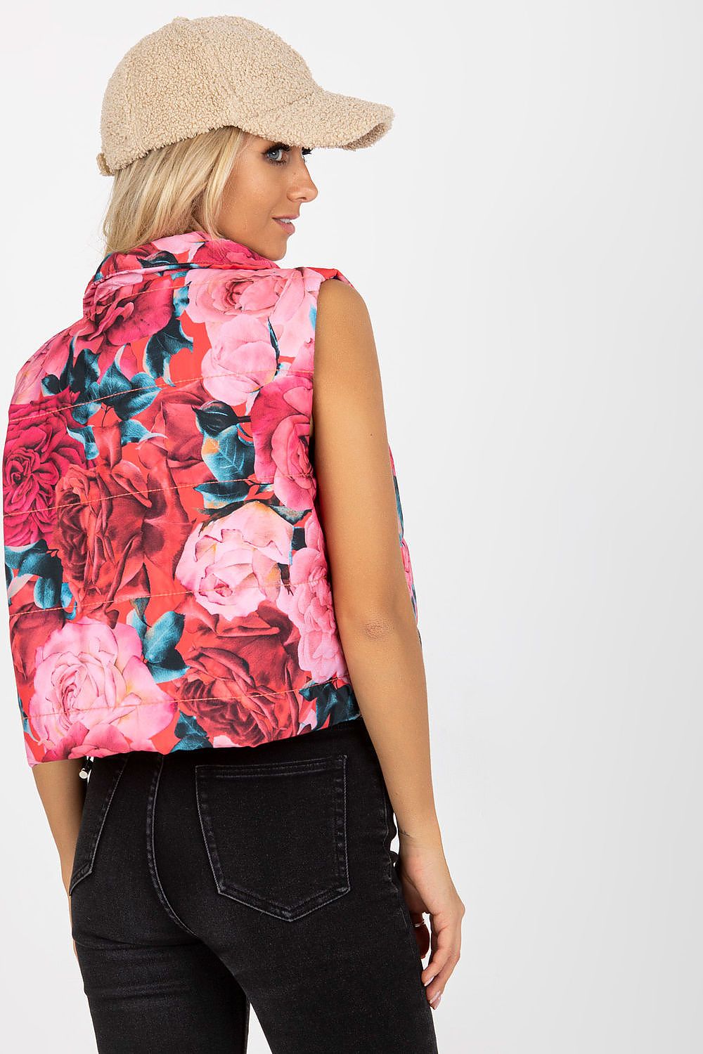 Back view of a luxurious floral quilted vest on a stylish model, highlighting the vibrant colours and delicate floral detailing, paired with a trendy cap.