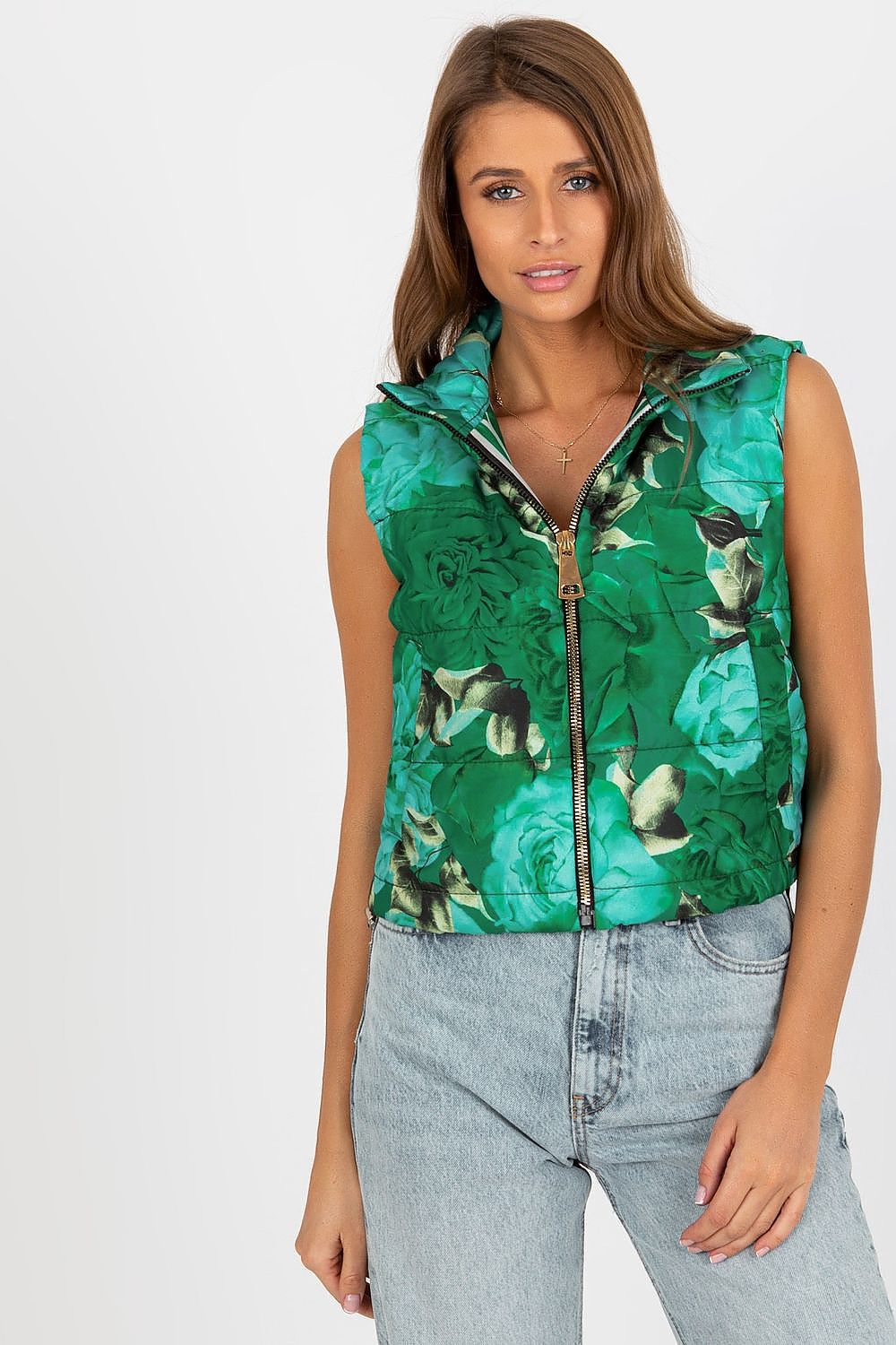 Elegant floral quilted insulated vest with a vibrant green pattern, styled with casual denim for a chic look.