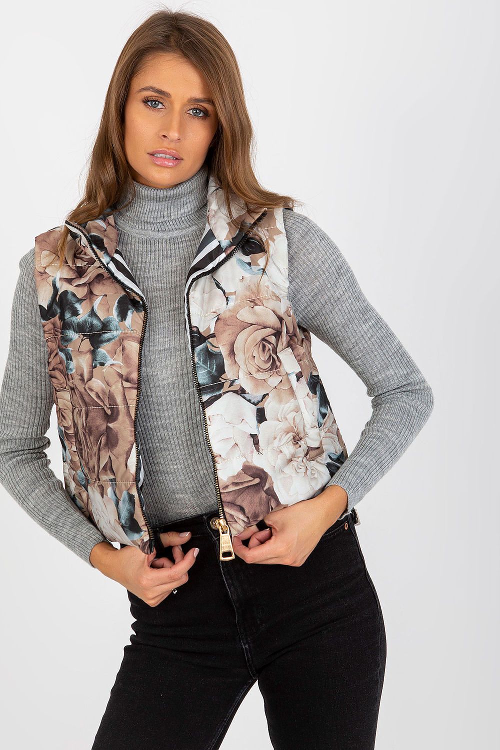 Sophisticated floral quilted vest in earthy tones, featuring a zippered design, paired with a grey turtleneck for a stylish ensemble.
