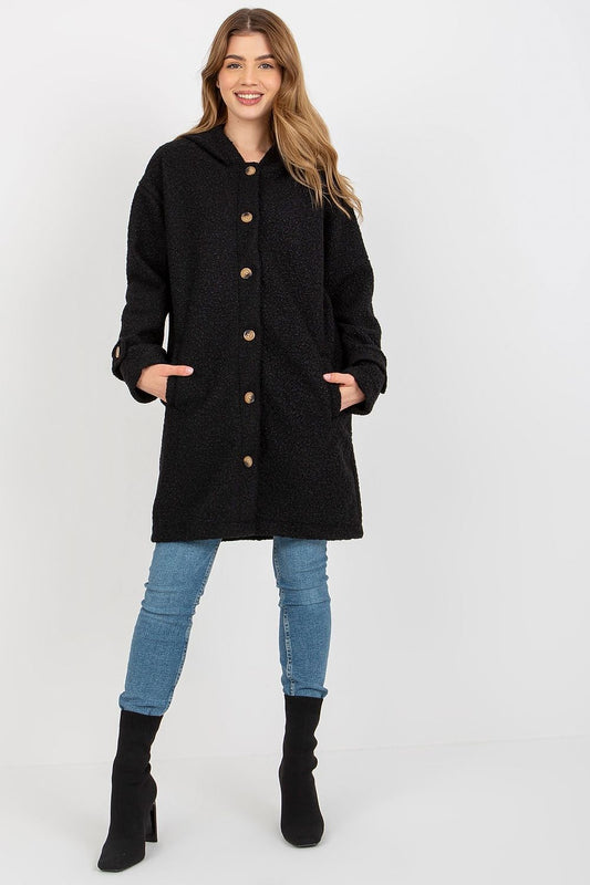 Luxurious long sleeve black plush coat with button closure, hood, and slip pockets, model showcasing style and comfort.