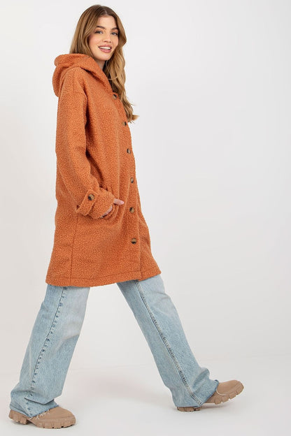Stylish orange plush coat with a modern fit, model captured in motion to highlight its fashionable and comfortable design.