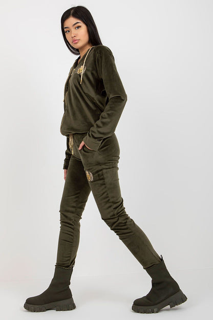 Elegant ladies' velour sweatshirt and pants set in deep olive green, featuring embroidery and a hood, styled with a fashionable stance.
