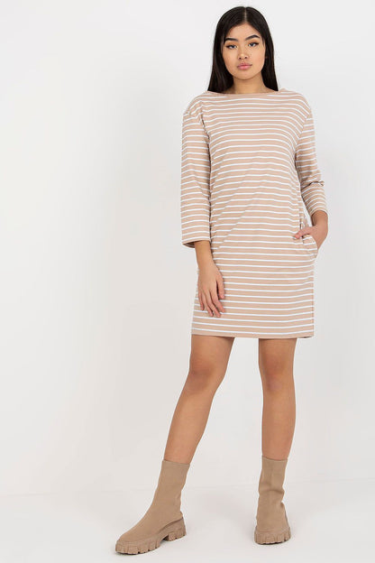 Model wearing the Elegant Stripe Daydress with Long Sleeves and Slip Pockets by Rue Paris, demonstrating its flattering fit and chic, casual look.