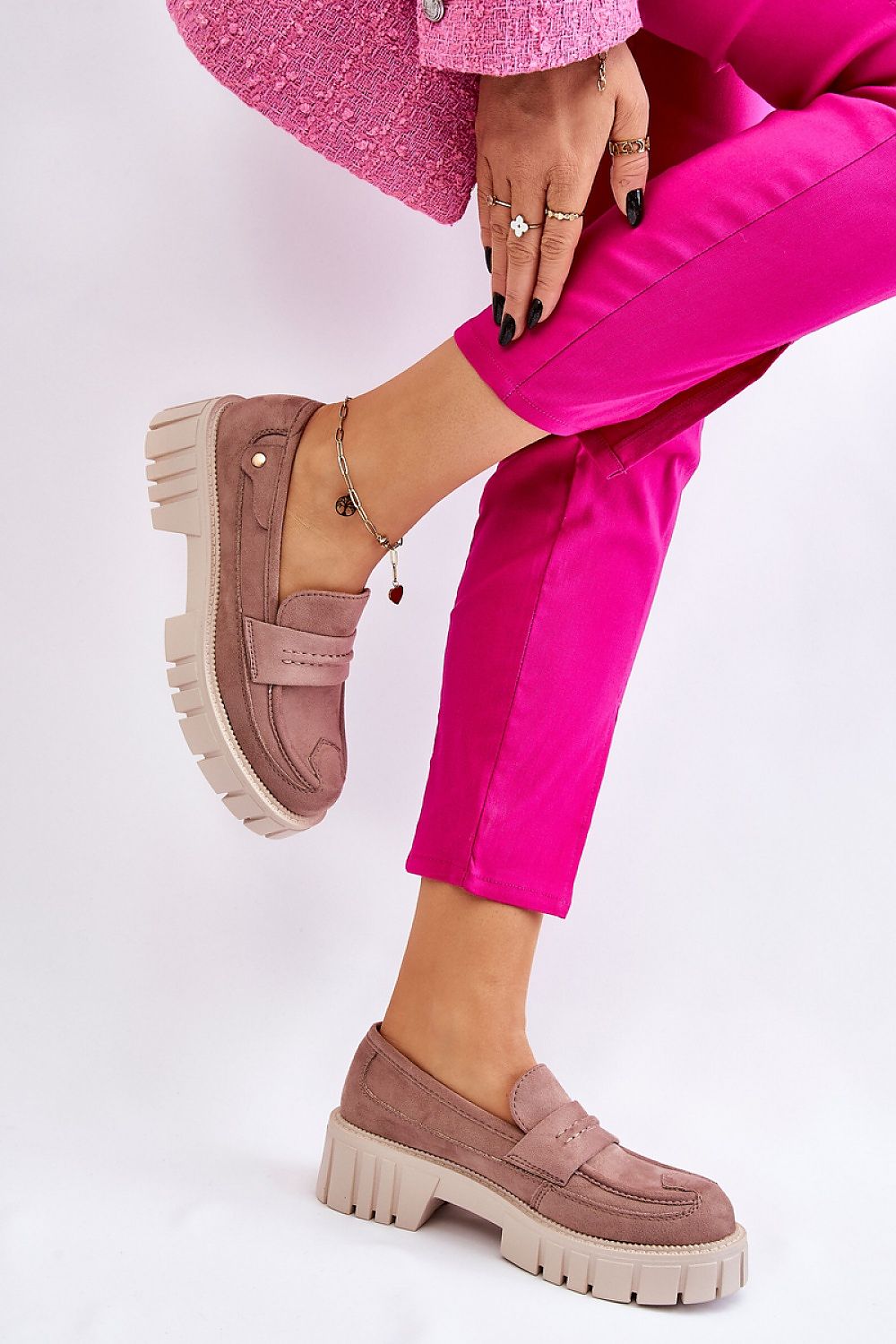 Sophisticated view of eco leather loafers with a chunky platform and rivet accents, paired with fashionable pink trousers, presented by Step in Style.