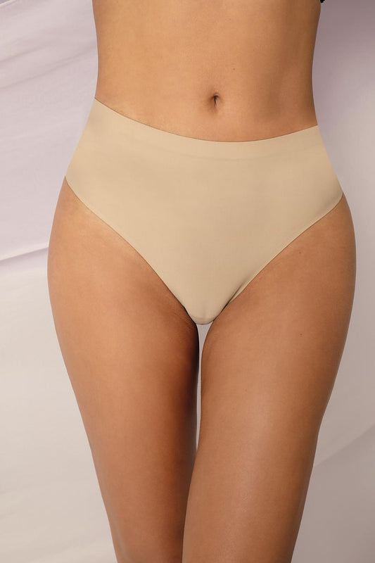 Elegant Beige Thong T-back by Unikat, designed for invisibility under fitted clothing. Available in sizes S-XL, showcasing a luxurious smooth finish and flat edge trim.