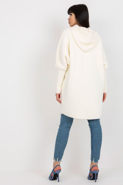 Model showcasing the Luxury Women's Coat MBM with Hood, highlighting its stylish long sleeves and versatile zippered design in a beautiful outdoor setting.