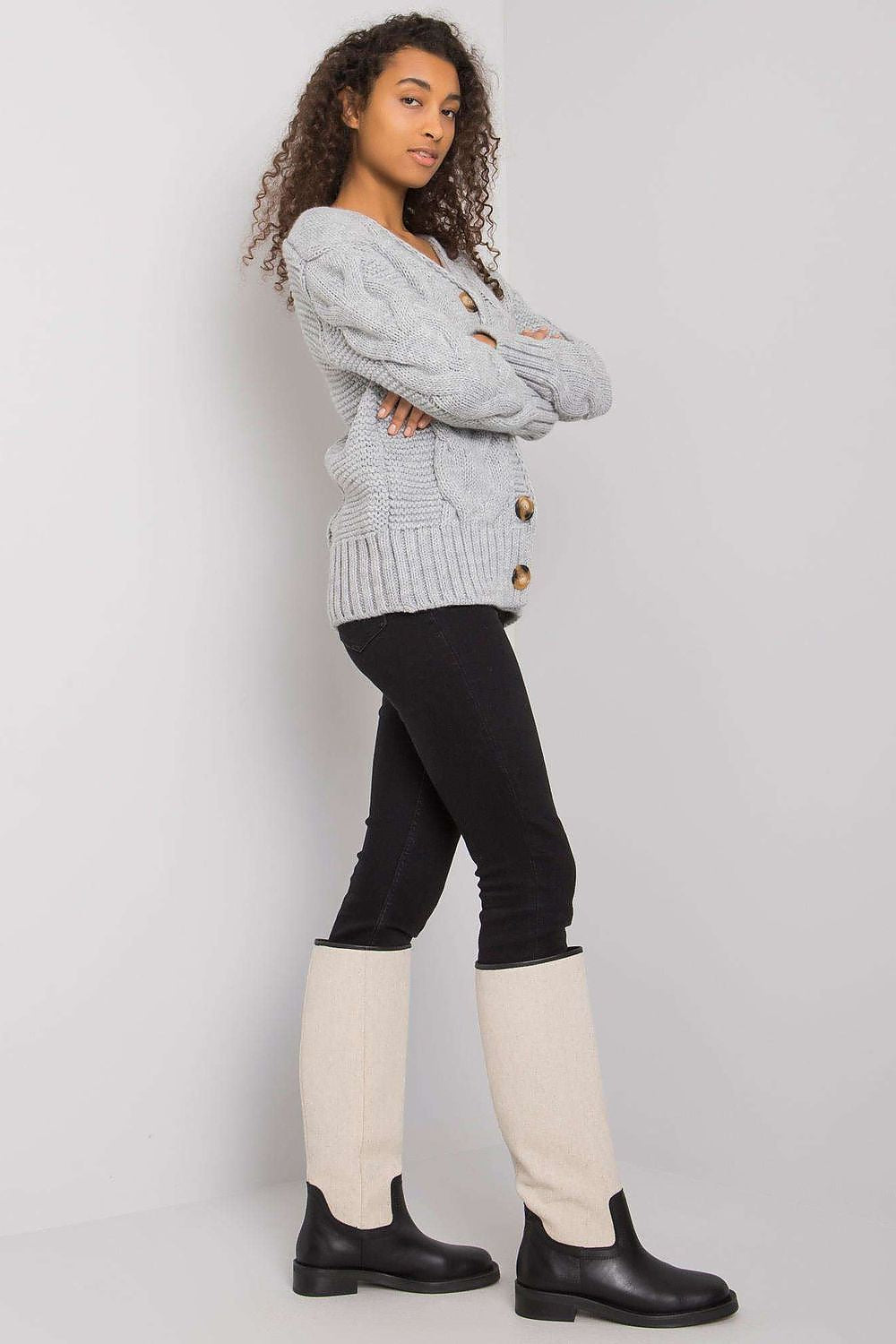 Stylish model wearing the Luxurious Women's Cardigan by Rue Paris, featuring a button-down front and long sleeves.