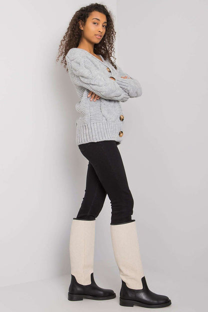 Stylish model wearing the Luxurious Women's Cardigan by Rue Paris, featuring a button-down front and long sleeves.