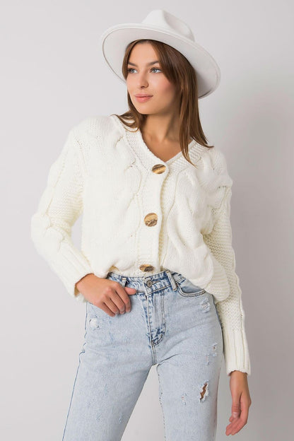 The Luxurious Women's Cardigan by Rue Paris - a fashionable button-down sweater with a unique heart neckline in a chic pose.