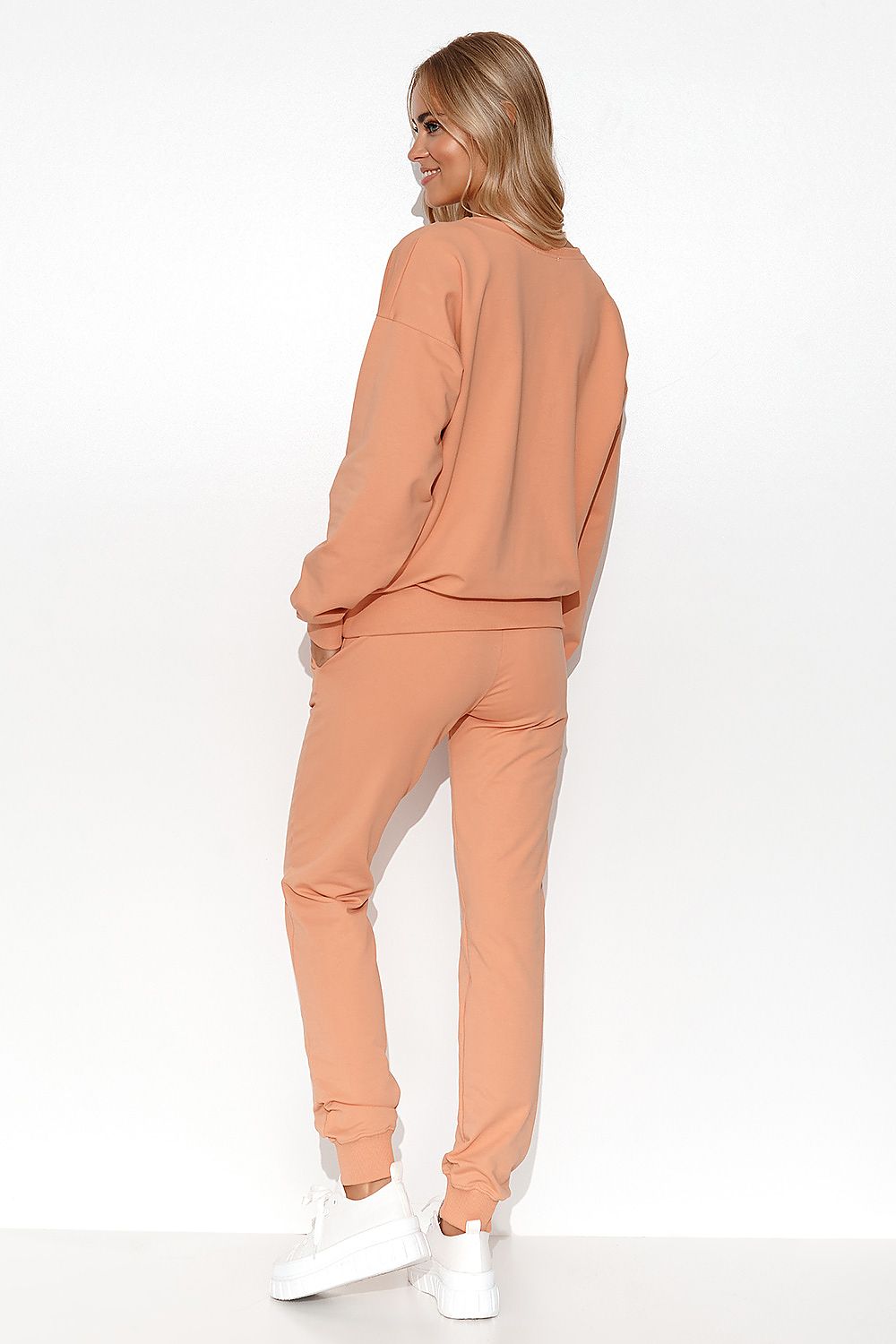 Side view of Luxury Women's Lightweight Knit Sweatshirt and Pants Set, featuring side slip pockets and ribbed cuffs for a chic look.