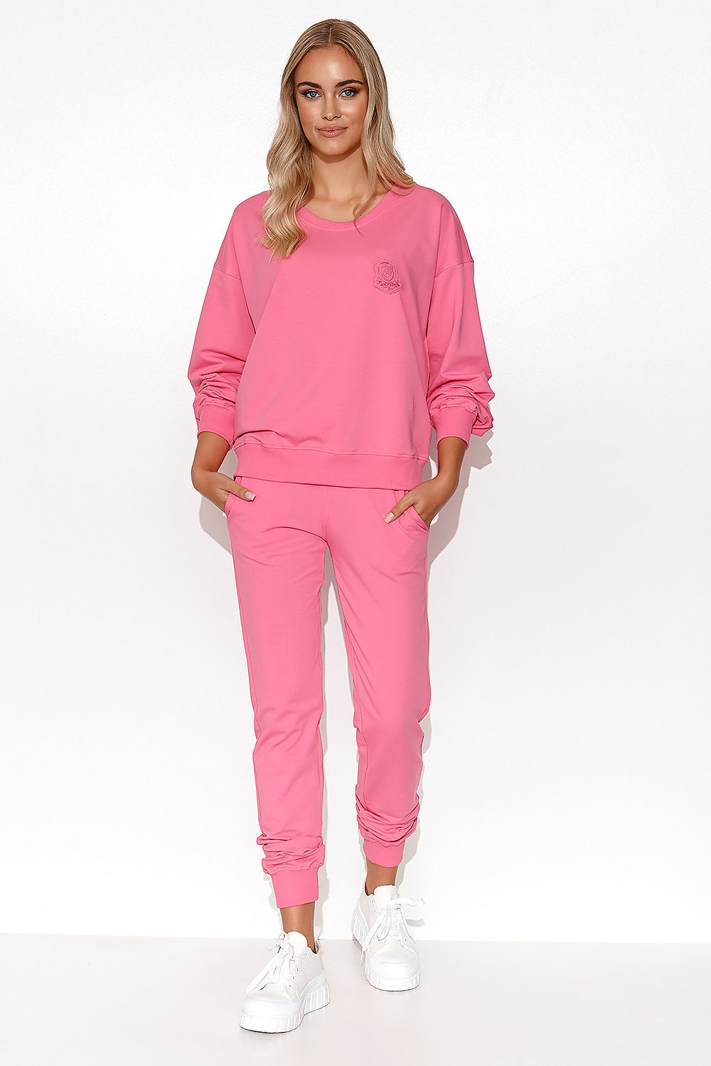 Model showcases the Luxury Women's Lightweight Knit Sweatshirt and Pants Set with collarbones reveal and stylish side slip pockets, perfect for chic loungewear.