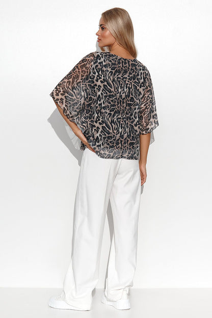 Sleek Makadamia Women's Airy Blouse featuring kimono sleeves and a solid base, perfect for pairing with trousers or skirts for a sophisticated look.