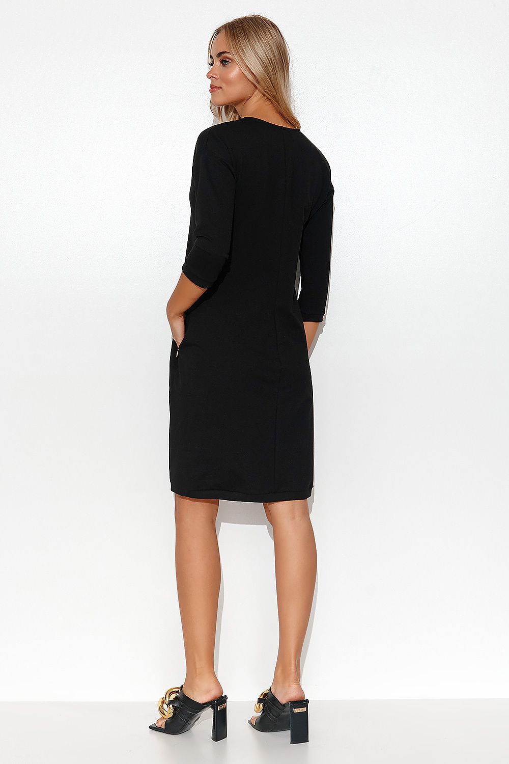 Front view of Stylish Makadamia Tracksuit Dress with V-Neck, 3/4 Sleeves and Pockets, capturing its chic silhouette.