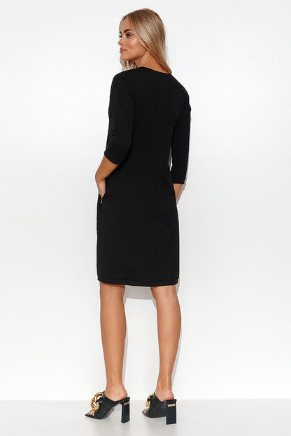 Front view of Stylish Makadamia Tracksuit Dress with V-Neck, 3/4 Sleeves and Pockets, capturing its chic silhouette.