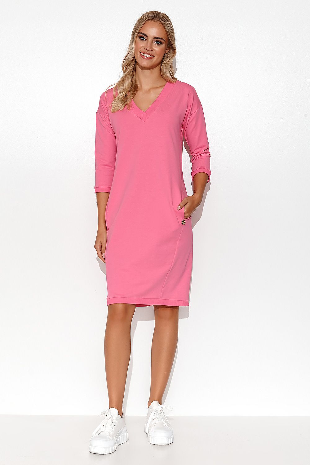 Stylish Makadamia Tracksuit Dress featuring a deep V-neck, 3/4 sleeves, and practical side pockets - a luxurious choice for perfect summer attire.