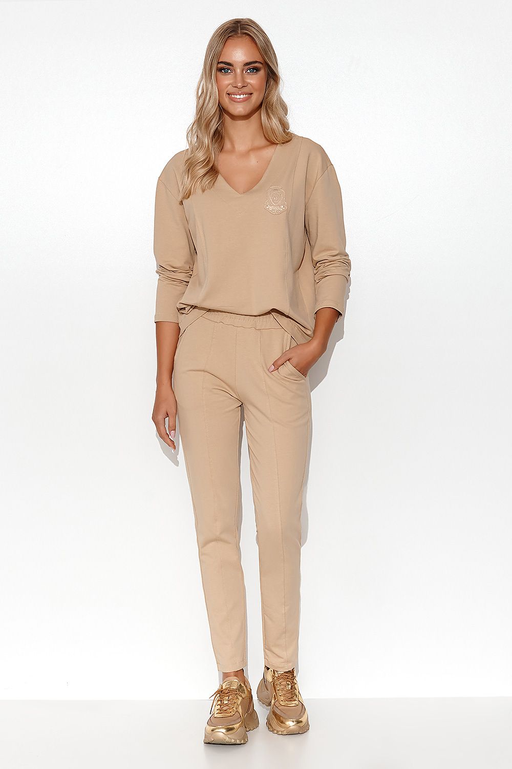 Sophisticated look of the Elegant Makadamia Women's Tracksuit Set showcasing the straight leg pants with slip pockets for a balanced blend of style and functionality.