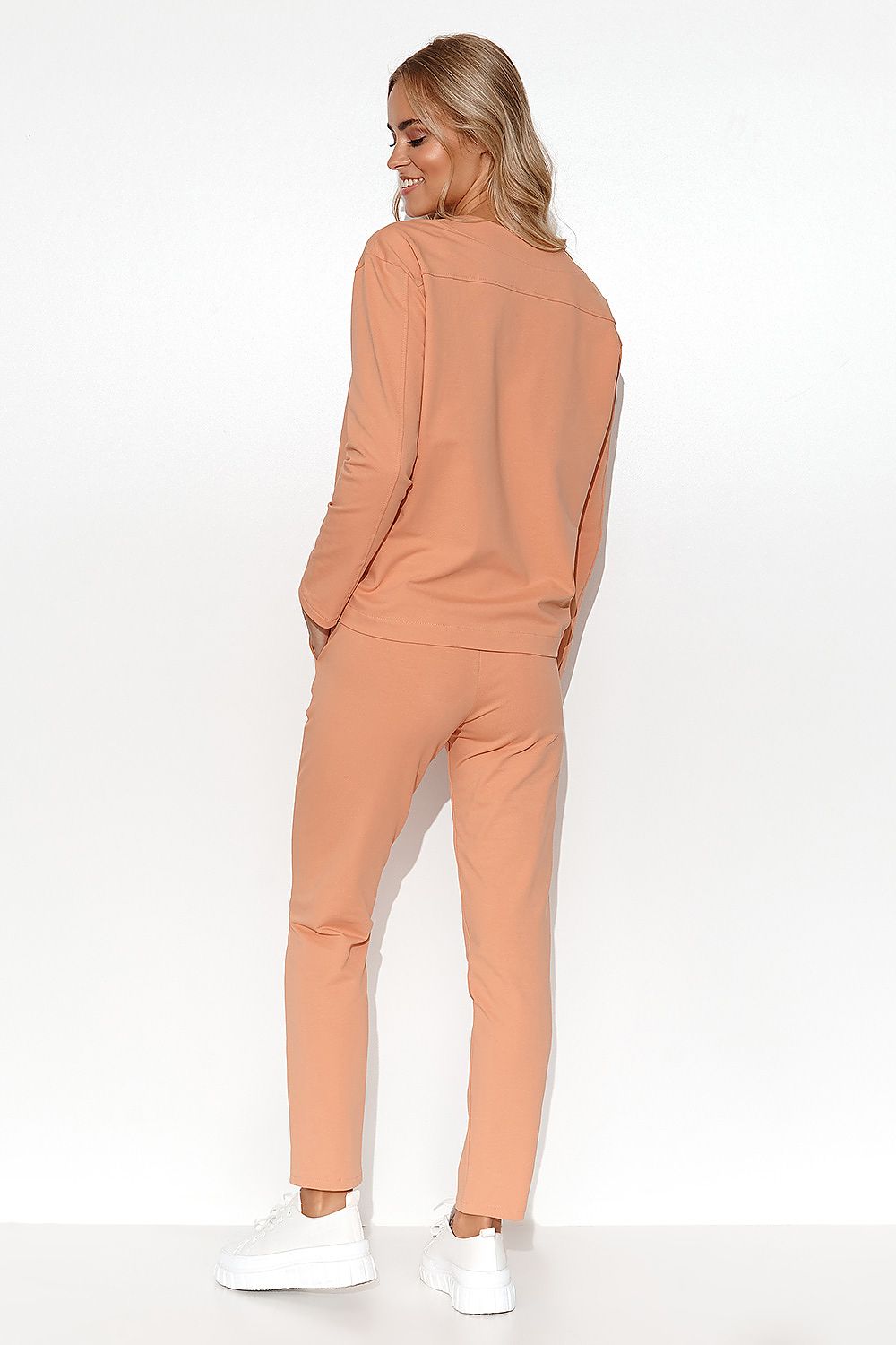 Close-up of the Elegant Makadamia Women's Tracksuit Set with V-Neck Blouse, highlighting the deep v-neck and exquisite detailing.