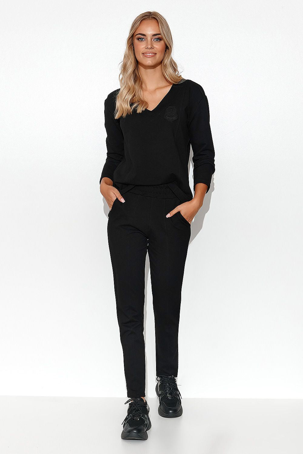 Elegant Makadamia Women's Tracksuit Set, showcasing the straight leg pants with slip pockets and luxurious stitching.
