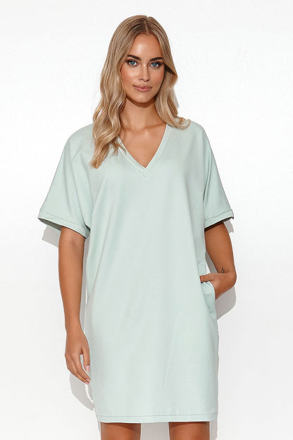 Backdrop focusing on the stylish details of the Luxury Makadamia Kimono Dress, epitomising relaxed luxury with a cotton blend finish.