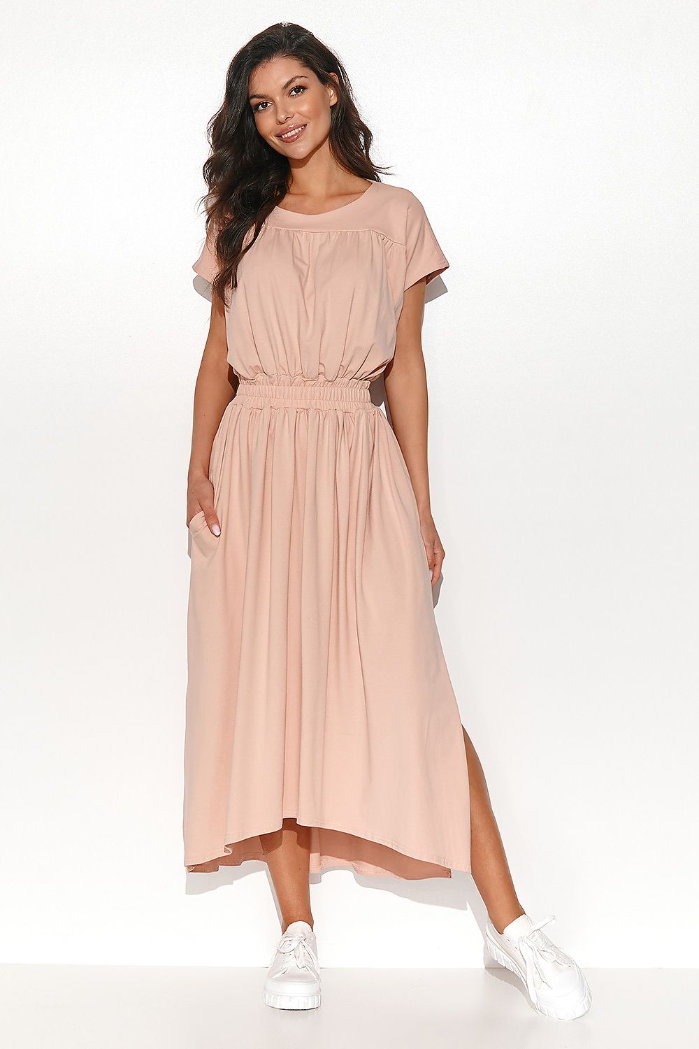 Numinou Long Asymmetrical Dress with Drawstring Waist and Side Pockets - Model wearing the dress, demonstrating its stylish silhouette complemented by side pockets.