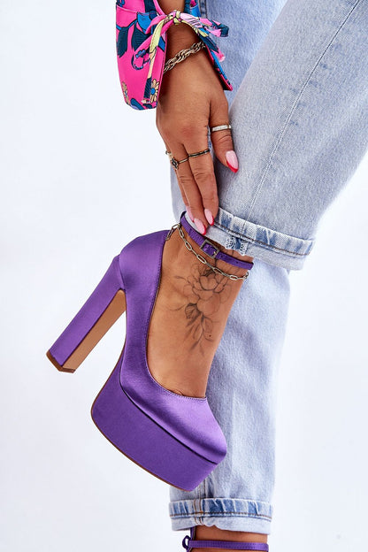 Elegant close-up of Step in Style purple block heel pumps with adjustable strap, showcasing sophisticated design paired with casual denim.