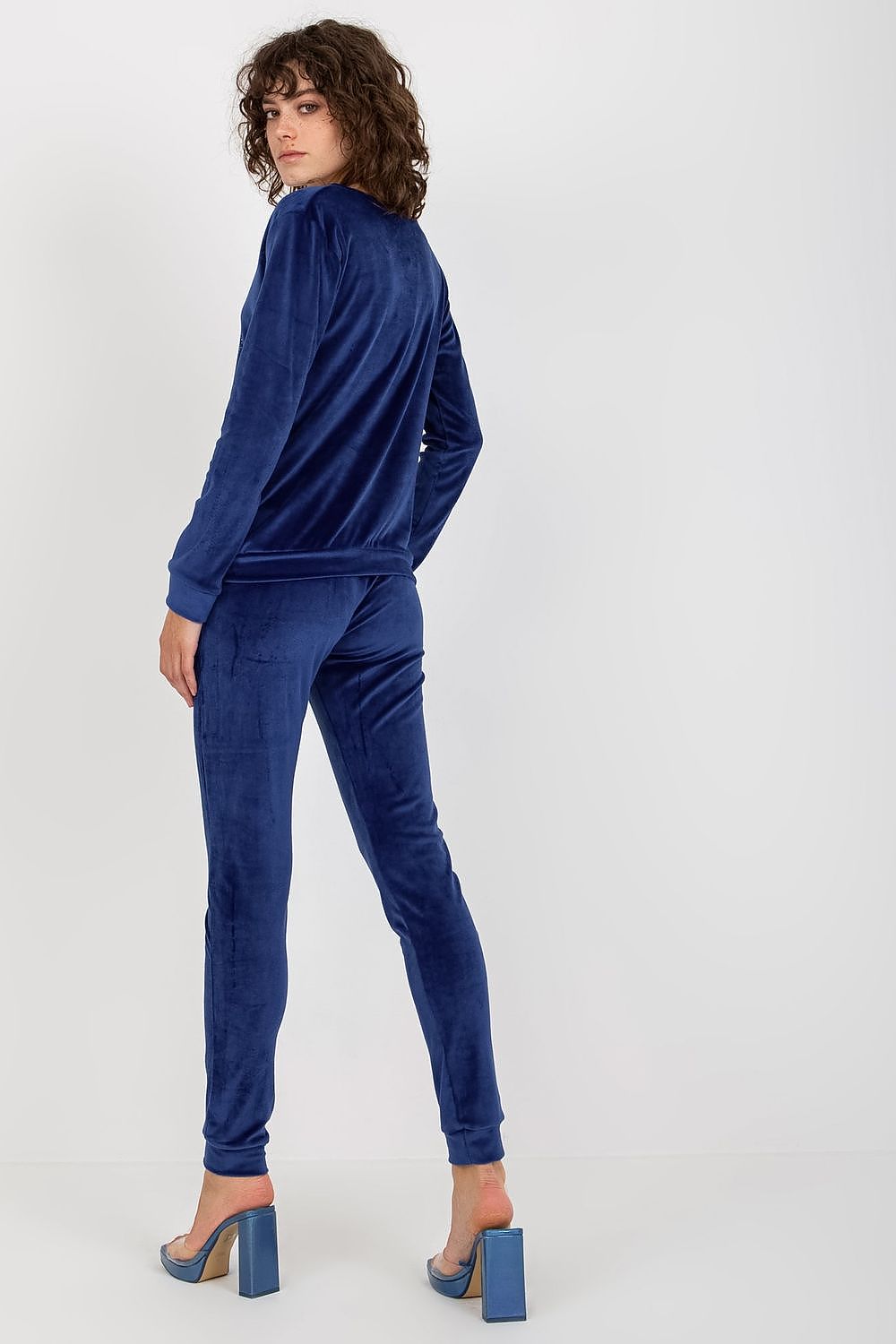 Stylish navy blue velour blouse and pants set with refined detailing, presented by Relevance, highlighting a sophisticated and luxurious appearance.