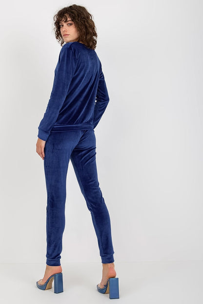 Stylish navy blue velour blouse and pants set with refined detailing, presented by Relevance, highlighting a sophisticated and luxurious appearance.
