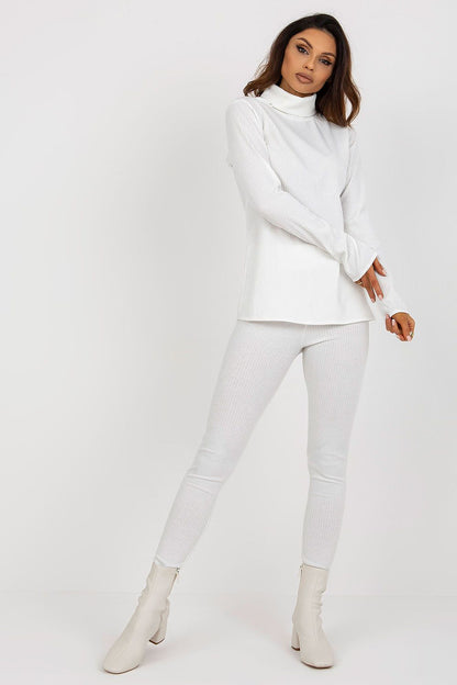 Elegant luxury women's turtleneck blouse in ribbed fabric by Lakerta, featuring long sleeves and styled with chic beige ankle boots, exuding sophistication.
