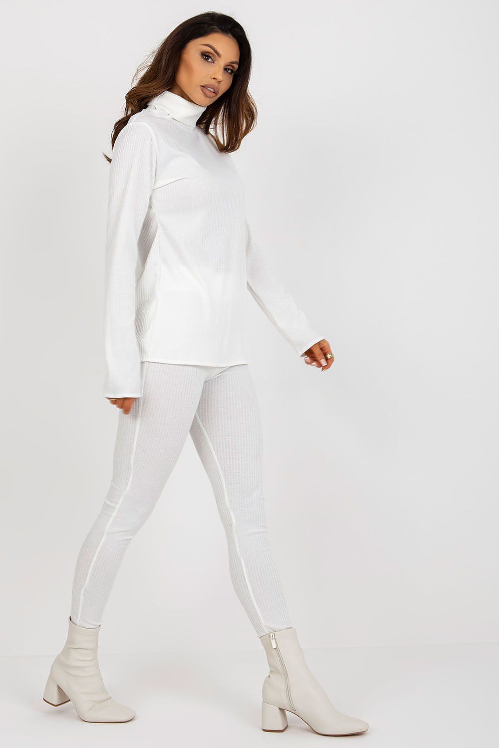Fashionable luxury women's turtleneck blouse from Lakerta in ribbed fabric, paired with stylish beige ankle boots, showcasing an elegant silhouette.