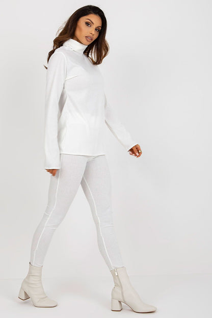 Fashionable luxury women's turtleneck blouse from Lakerta in ribbed fabric, paired with stylish beige ankle boots, showcasing an elegant silhouette.