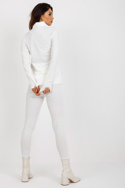 Stylish back view of a woman wearing a luxury white ribbed turtleneck blouse and matching leggings by Lakerta, embodying elegance and sophistication.