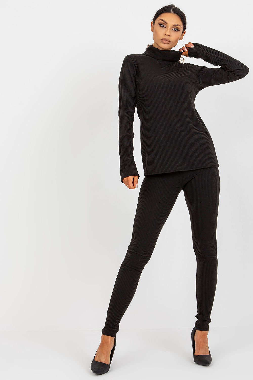 Fashionable full-body shot of a woman wearing a black ribbed turtleneck blouse and leggings by Lakerta, perfect for a sophisticated look.