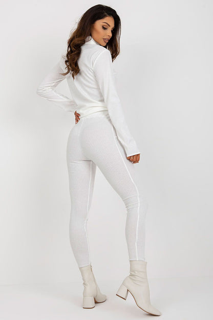 Refined back view of a model in white high waist striped leggings by Lakerta, complemented by chic white footwear, embodying luxury and style.