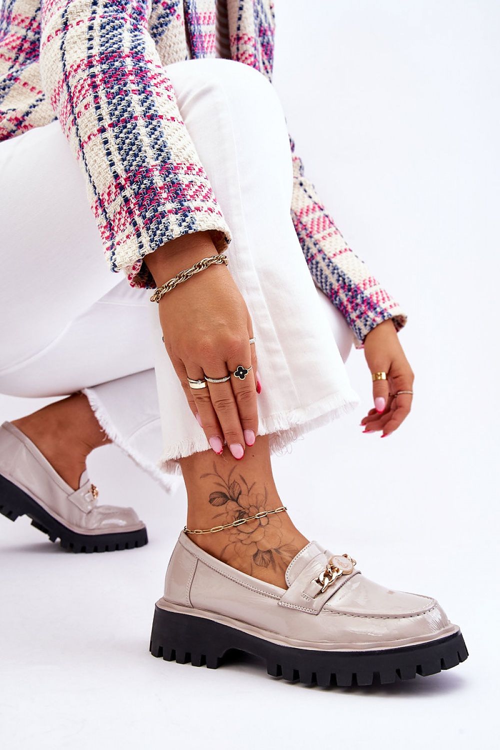 Close-up of Eco Leather Moccasin Shoes with decorative chain by Step in Style, beautifully styled with white frayed jeans and intricate jewellery, highlighting versatility in fashion.