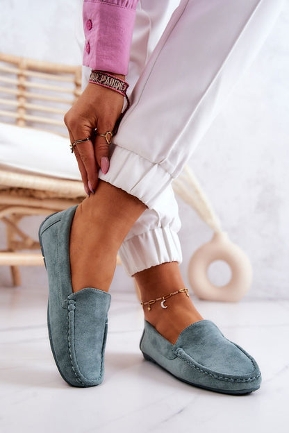 Luxury suede moccasins in soft blue worn stylishly with white joggers, showcasing elegant comfort by Step in Style.