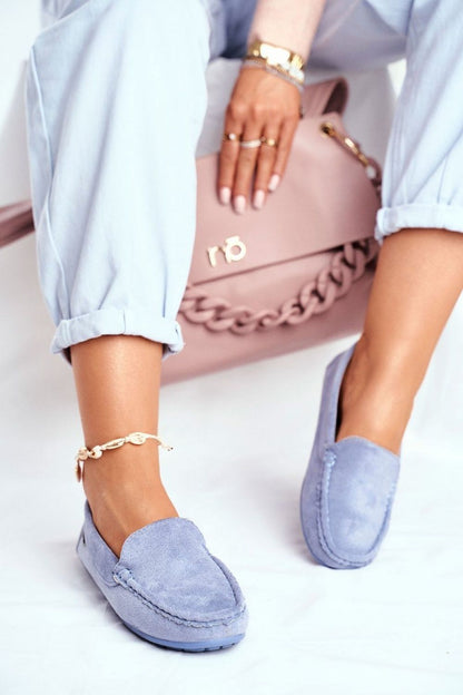 Chic light blue moccasins showcased with a stylish handbag, designed for comfort and elegance with a natural leather insole by Step in Style.