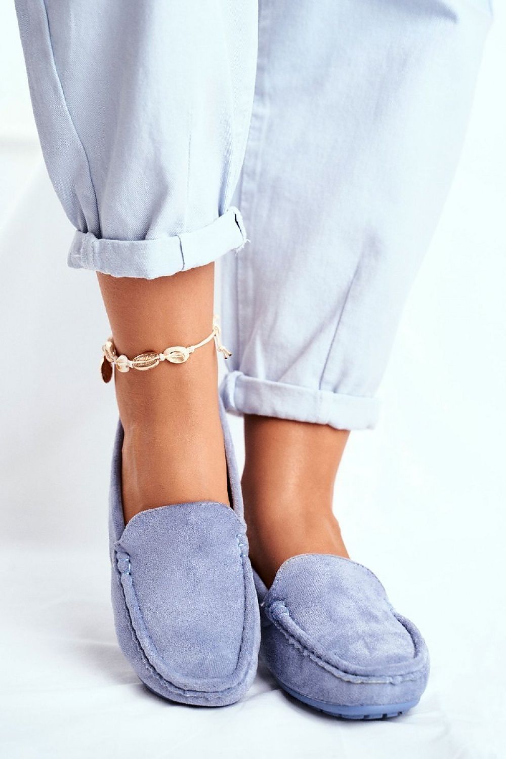 Fashionable light blue moccasins accentuated by rolled-up trousers, showcasing a comfortable and stylish design with natural leather insole by Step in Style.