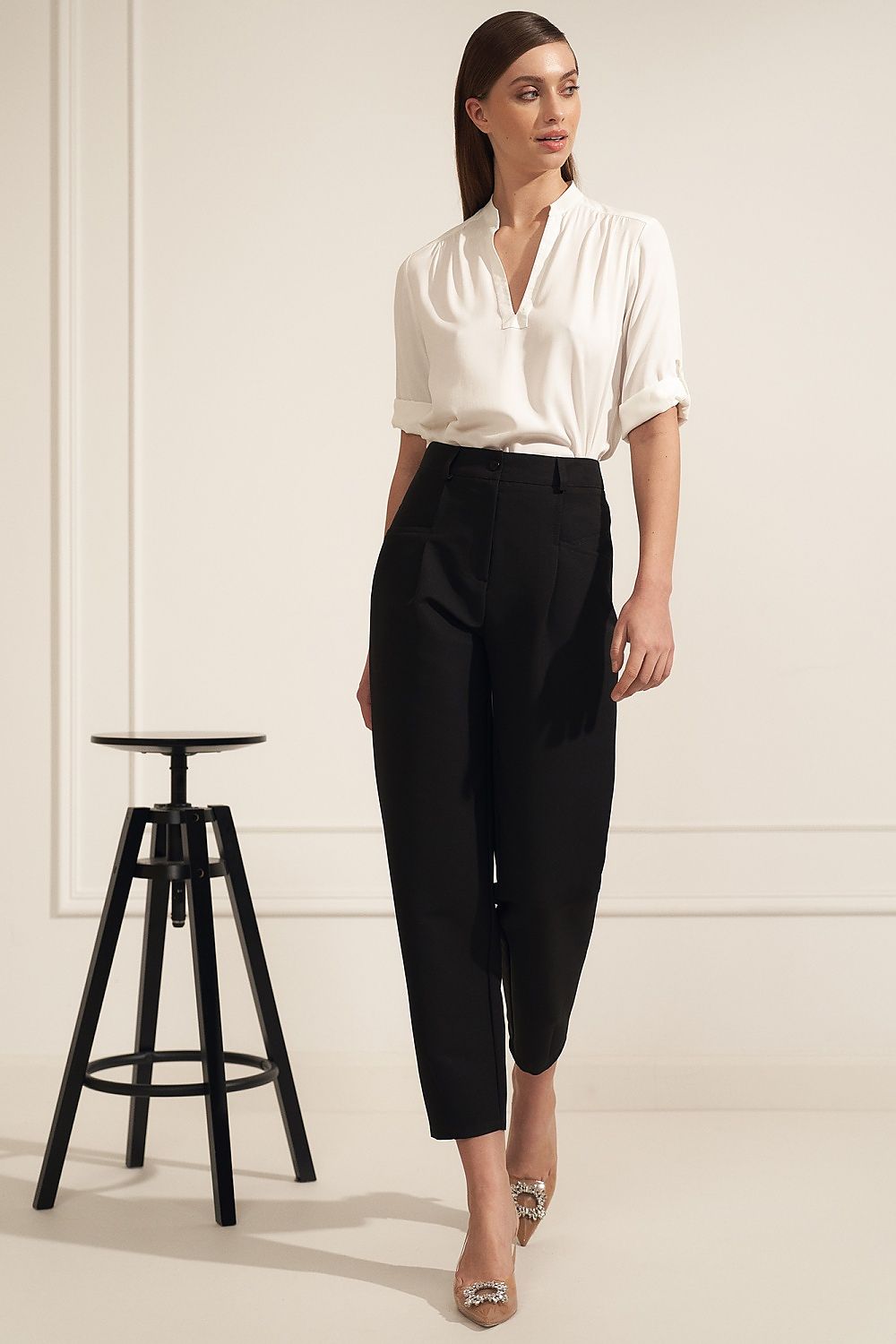 Sophisticated Nife viscose blouse elegantly paired with tailored black trousers, showcasing a modern neckline and rolled sleeves, ideal for chic workplace fashion.