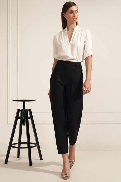 Sophisticated Nife viscose blouse elegantly paired with tailored black trousers, showcasing a modern neckline and rolled sleeves, ideal for chic workplace fashion.