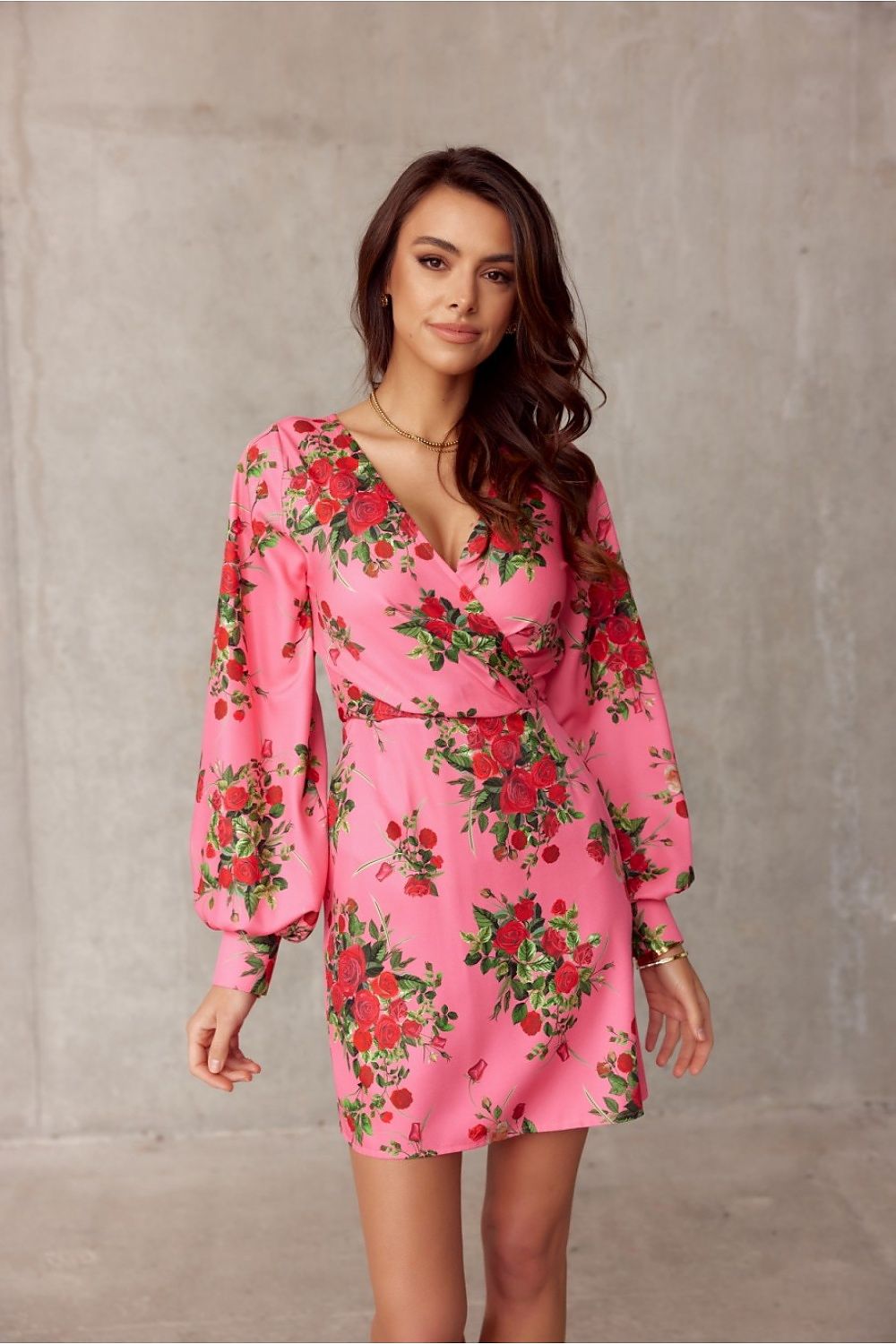 Elegant pink floral mini cocktail dress with deep neckline and long sleeves by Roco Fashion, perfect for special occasions.