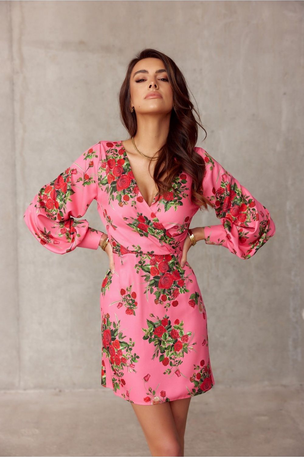 Chic pink floral mini dress featuring a deep V-neckline and gently flared sleeves by Roco Fashion, ideal for creating a striking look.