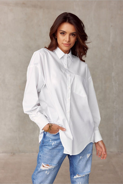 Timeless white oversized shirt from Roco Fashion, accented with a classic collar and front pocket, paired with distressed jeans for a stylish casual ensemble.
