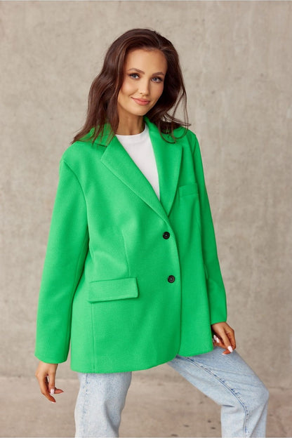Sophisticated green voluminous jacket from Roco Fashion, showcasing a structured silhouette with imitation pockets, paired with a white shirt and denim, embodying a perfect blend of elegance and modernity.