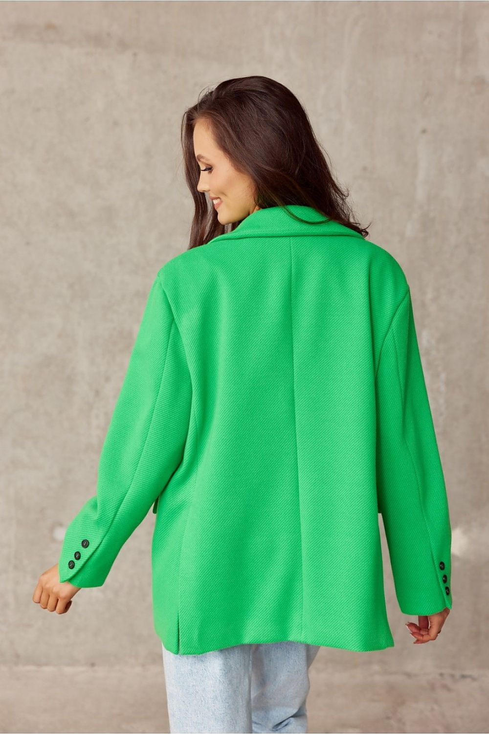 Back view of a stylish green voluminous jacket by Roco Fashion, featuring a decorative collar and elegant button details, perfect for a chic and contemporary look.