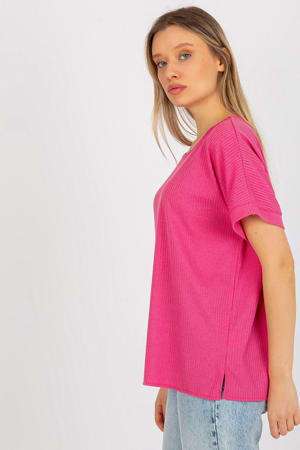 Side view of the luxury loose fit ribbed cotton blouse in pink by Lakerta, highlighting its elegant design and relaxed silhouette, ideal for a stylish everyday ensemble.