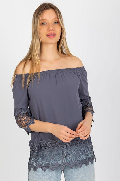 Sophisticated model showcasing the Elegant Lakerta Blouse with 3/4 sleeves and Spanish neckline, adorned with decorative lace trim, ideal for upscale casual wear.