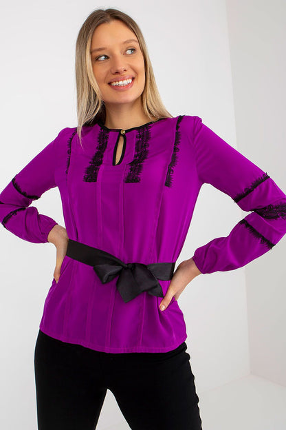 Elegant Lakerta long sleeve blouse featuring intricate lace detailing and a stylish tie belt, perfect for formal occasions. Vibrant purple colour enhances its luxurious appeal.