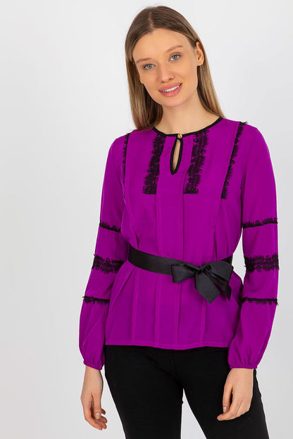 Elegant Lakerta long sleeve blouse in vibrant purple with intricate lace detailing and a stylish tie belt for a poised look.