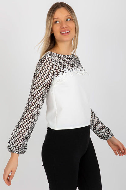 Captivating pose of a model in an elegant lace sleeve formal blouse by Lakerta, emphasising the sophisticated round neckline and intricate lace details.